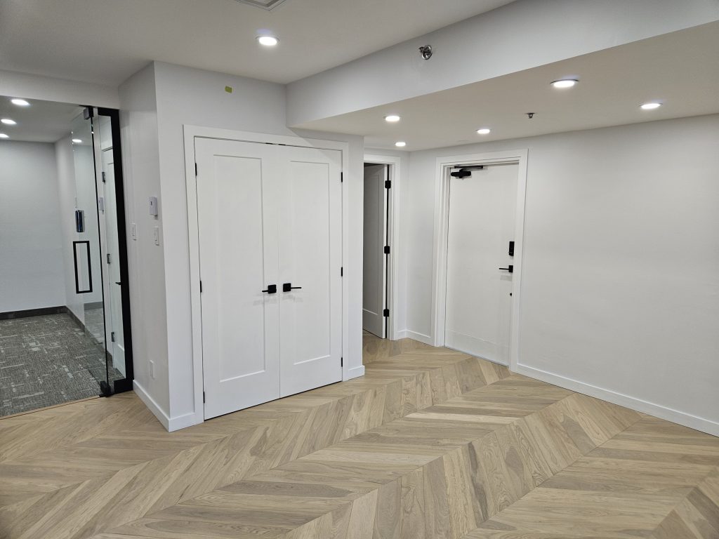 Design moderne d'espace de bureau commercial avec plancher en bois franc d'ingénierie par Design B Home à Montréal.